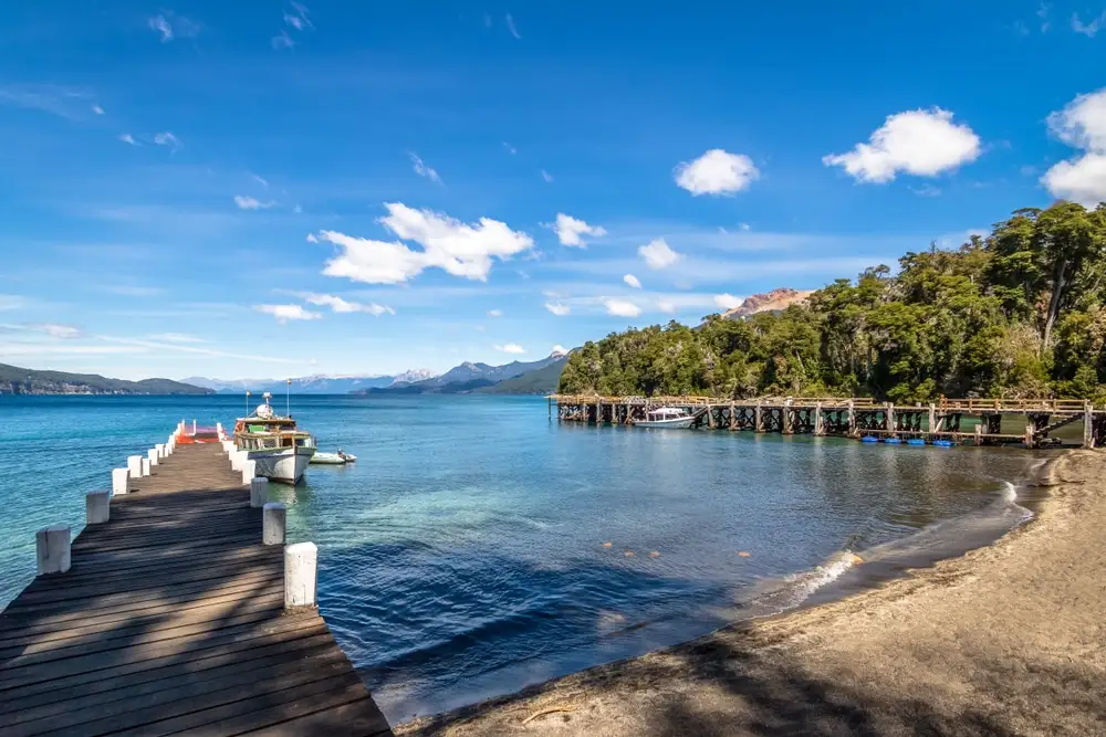 A jetty on the lake, with the wooded shore beyond