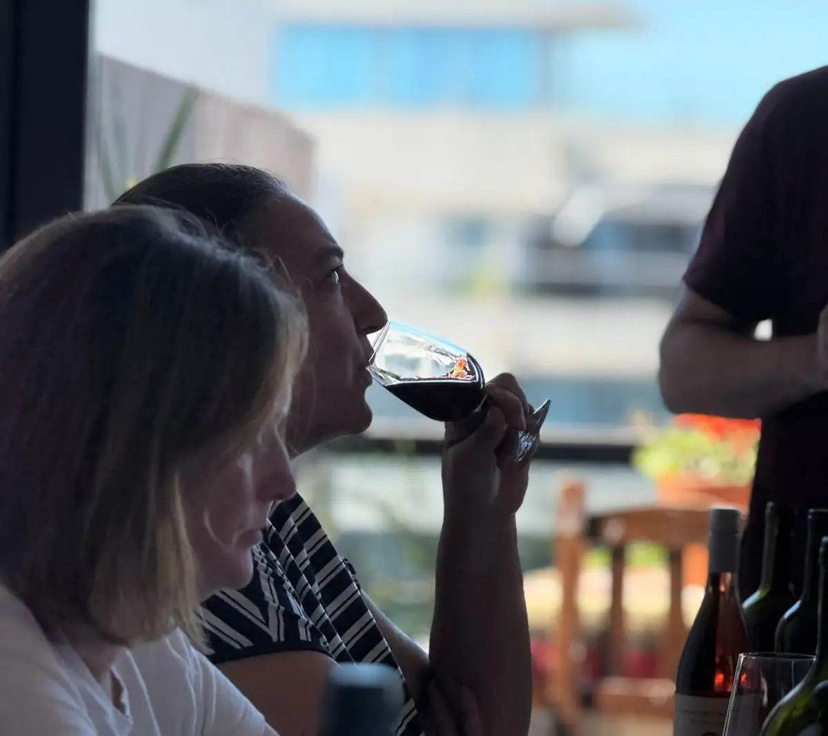 Two guests drinking wine at the table