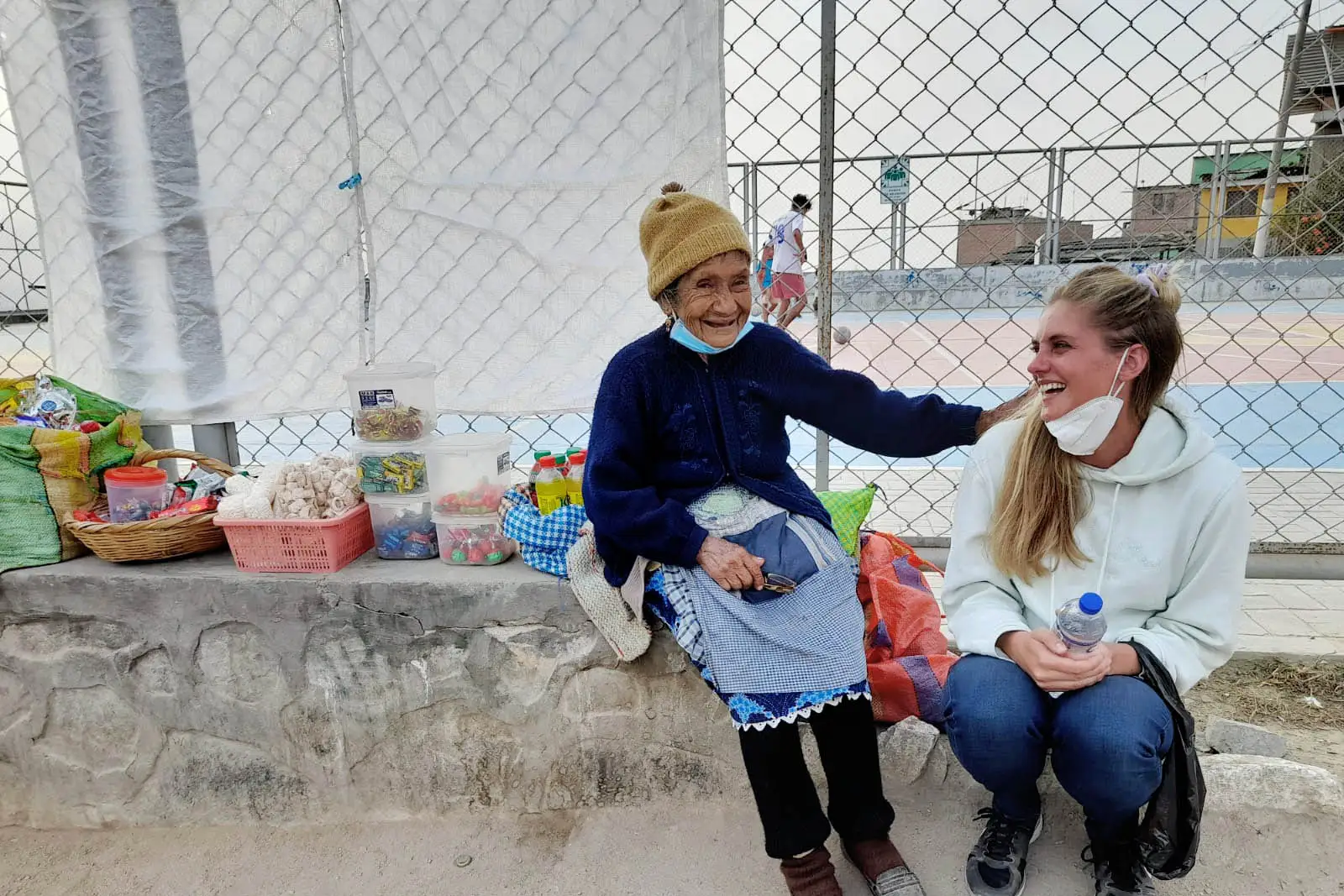 Local with tourist at the shanty town's local soccer field