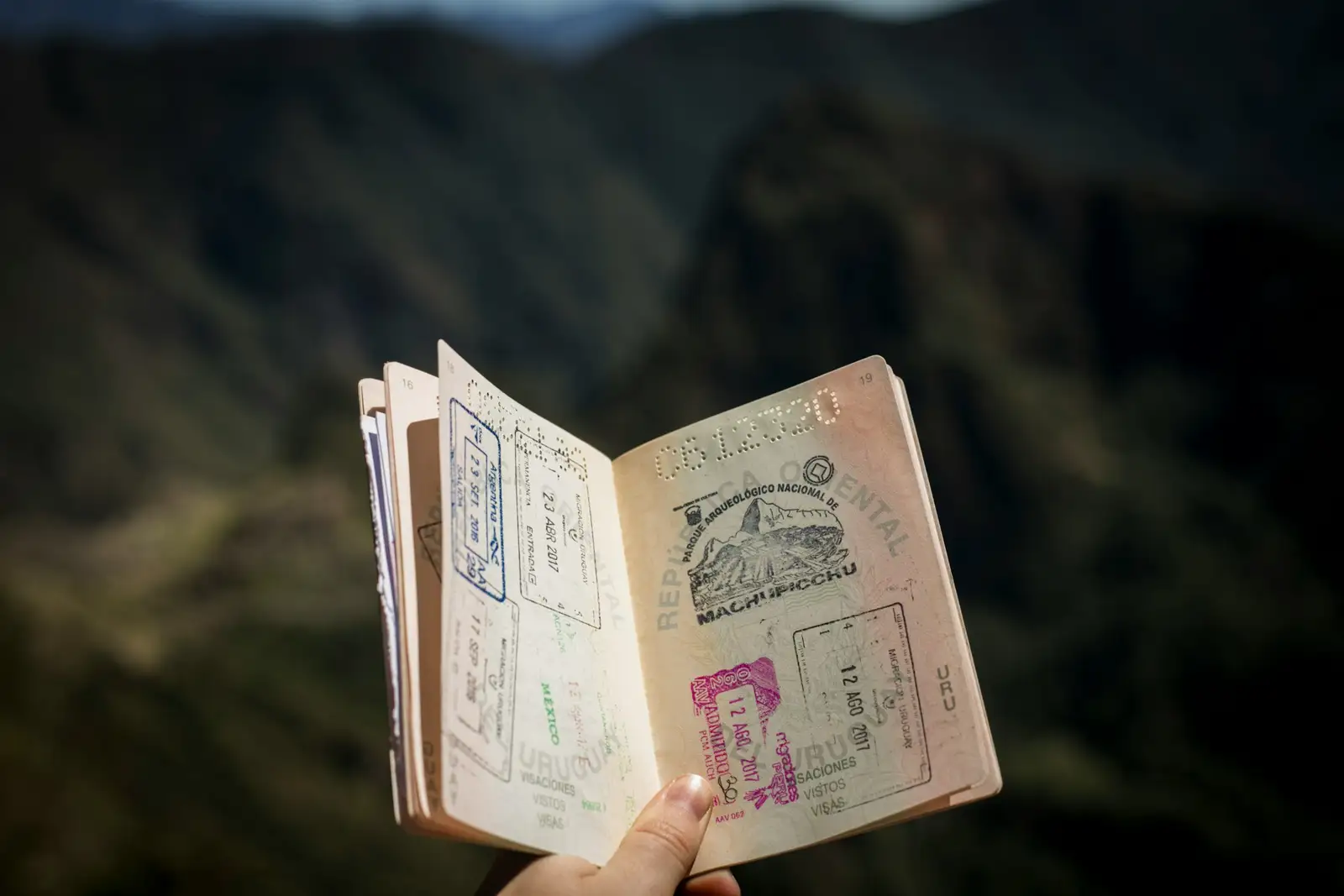 A passport held open, full of stamps